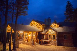 night photo of the custom designed log cabin in angel fire, New Mexico