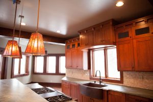 Custom Arts & Crafts style cabinets, granite kitchen counters, amber mica light fixtures.