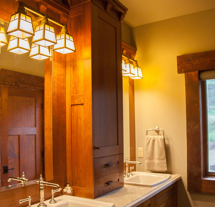Craftsman bathroom with handcrafted wood drawers and period light fixtures.